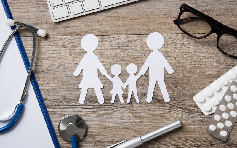 desk with family cutout and doctor tools