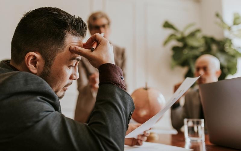 Man looking frustrated over a contract